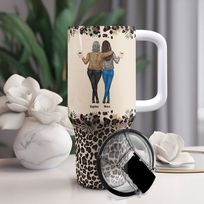 Personalized 40oz tumbler with straw, featuring "To My Badass Daughter" design and leopard print base, perfect gift.