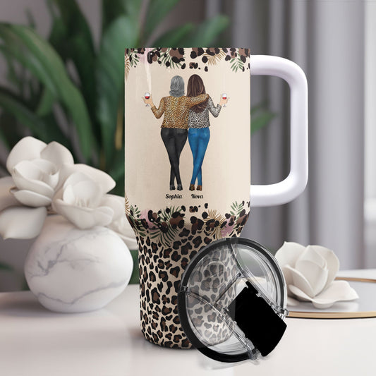 Personalized 40oz tumbler with straw, featuring "To My Badass Daughter" design and leopard print base, perfect gift.